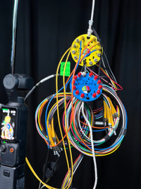 Butt Pucks organising cable runs on a broadcast cart